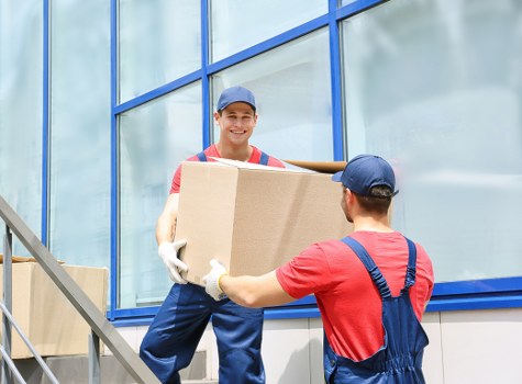 Moving team preparing items safely with protective equipment and planning