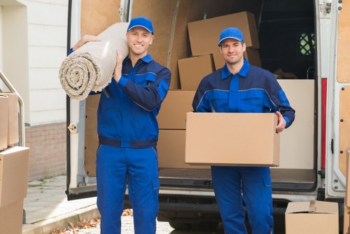 Movers carrying furniture down stairs during a flat removal