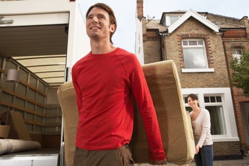 Commercial movers packing office furniture and equipment for relocation